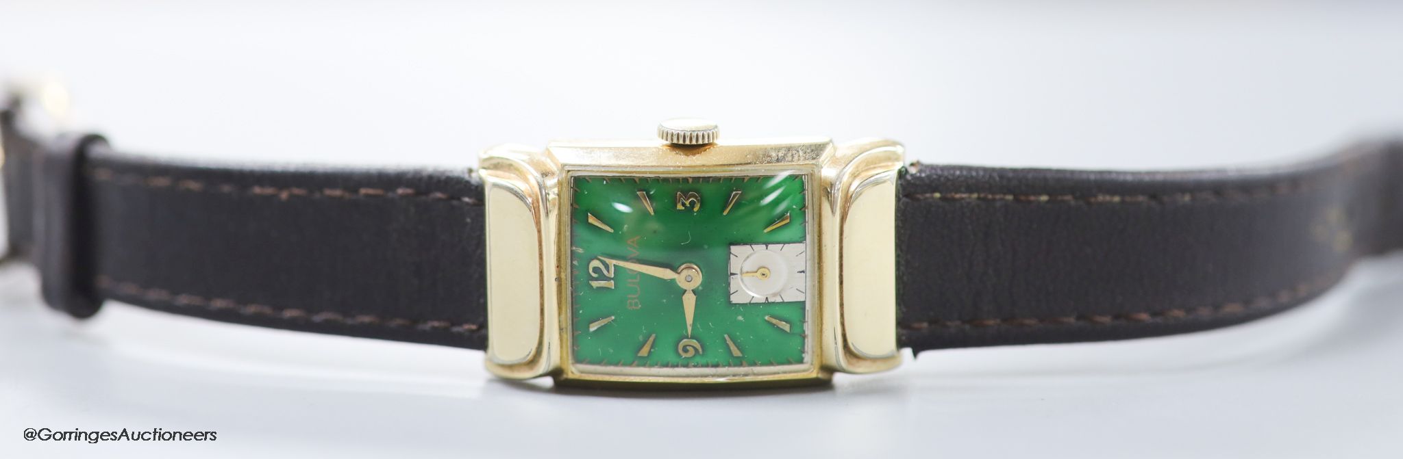 A gentleman's 1930's 10k gold filled Bulova manual wind wrist watch, with green enamel rectangular dial and subsidiary seconds, on later leather strap.